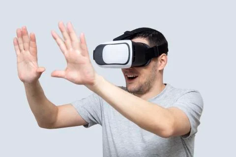 Young man using vr headset, experiencing virtual reality Stock Photos