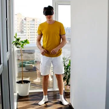 Young man using a VR headset to play fighting game. Portrait of a young man w Stock Photos