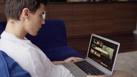 Young man using web search engine at home Stock Footage 128759455