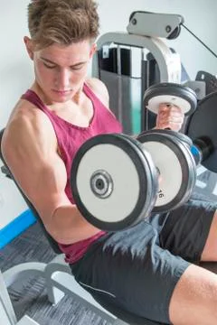 Young man using weights Fotos Stock