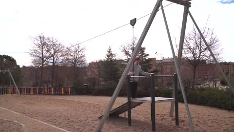 Young man using zip line in a playground in Madrid Stock-Footage 304538850