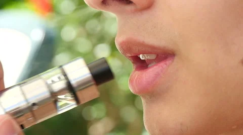 Young man is vaping e-cig, slow motion, close up  Stock-Footage 66553738