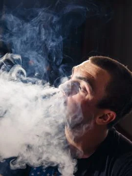 Young man vaping Stock Photos