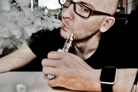 Young man vaping Stock Photos