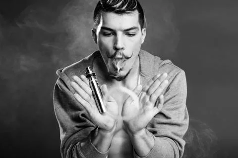 Young man vaping Stock Photos