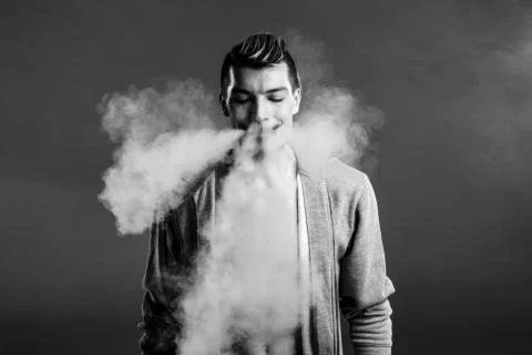 Young man vaping Stock Photos