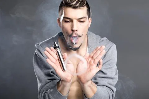 Young man vaping Stock Photos