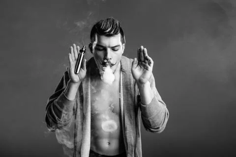Young man vaping Stock Photos
