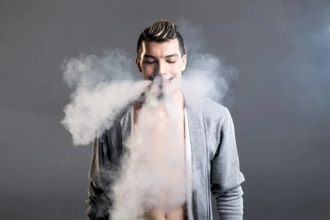 Young man vaping Stock Photos