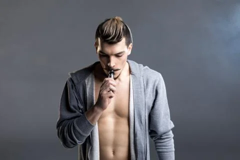 Young man vaping Stock Photos