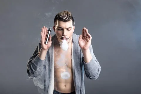 Young man vaping Stock Photos