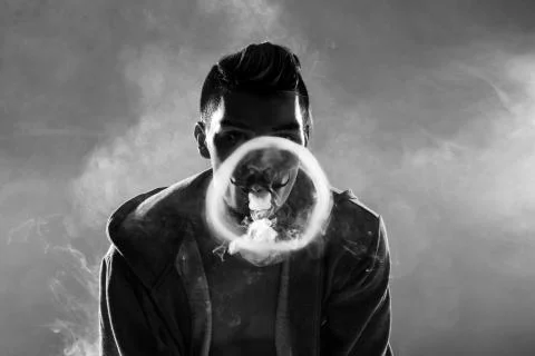 Young man vaping Stock Photos