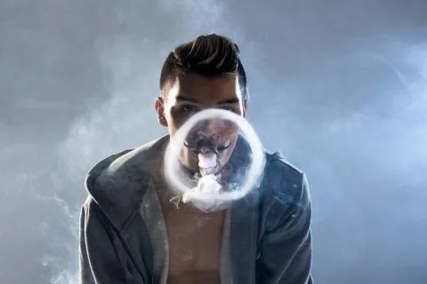 Young man vaping Stock Photos