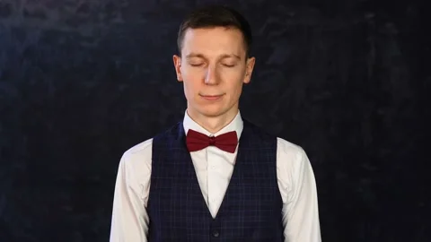 Young man in a vest, posing looking at camera, waving his head positively Stock Footage 152848954