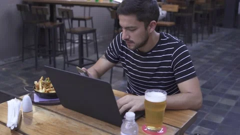 Young man in video call with mobile in bar Vídeo Stock 153294852