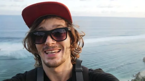 Young man video chats on smart phone on the beautiful landscape background Stock Footage 65005636