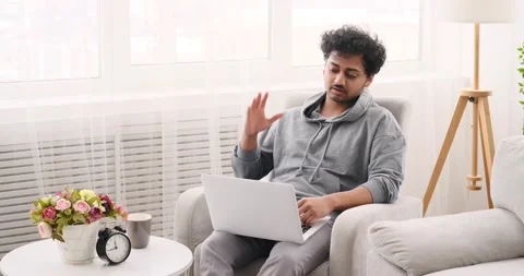 Young man video chatting using laptop Stock Footage 196079181