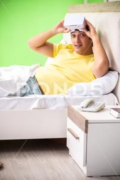 Young man with virtual glasses in the bedroom Stock Photos