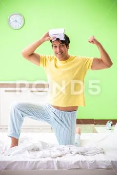 Young man with virtual glasses in the bedroom Stock Photos