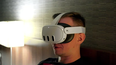 Young Man in virtual reality glasses white color playing games or surfing the Stock Footage 284478067