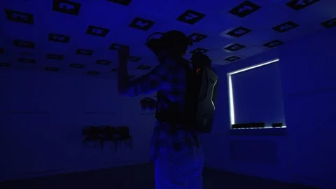 Young man in virtual reality headset is playing a vr videogame and throwing a Stock Footage 123556133
