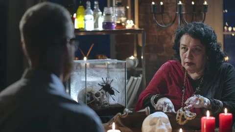 Young man visiting fortune teller gypsy doing seance Stock Footage 136892167