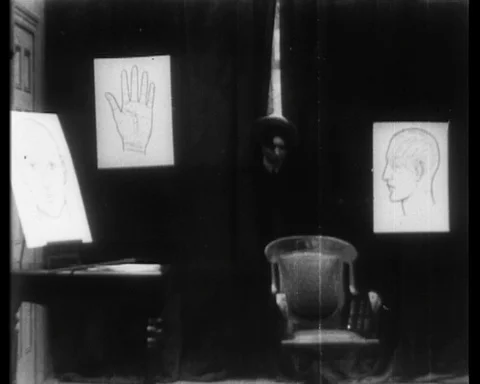 Young man visits a phrenologist to try and feel women's scalps, UK 1914 Stock Footage 136673714