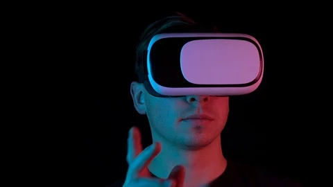 Young man in VR glasses closeup. A man immersed in virtual reality makes Stockbeeldmateriaal 123532213