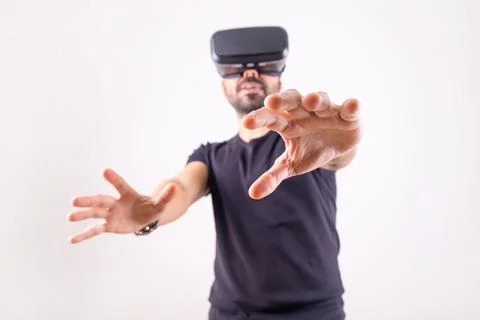 Young man in VR glasses headset gesturing excited portrait. Virtual reality Stock Photos
