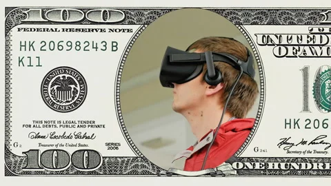 Young man in VR headset in frame 100 dollar bill Stock Footage 96343890