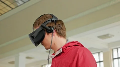 Young man in VR headset playing virtual game Stock Footage 80095024