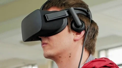 Young man in VR headset playing virtual game Stock Footage 80226755