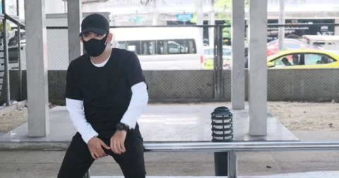 Young man waiting and doing street dance on rails, sitting down, sliding around. Stock Footage 106375490
