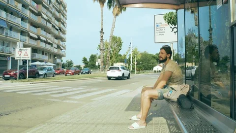 Young man waiting for a bus Stock Footage 125659299