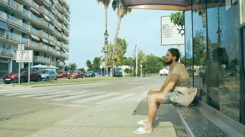Young man waiting for a bus Stock Footage 125660006