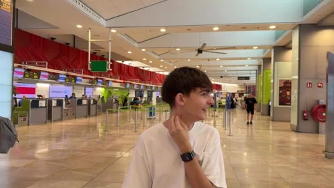 Young man waiting at the check-in area Vídeo Stock 344572002