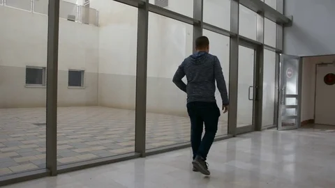 Young man waiting in hall with cellular Видео 82191698