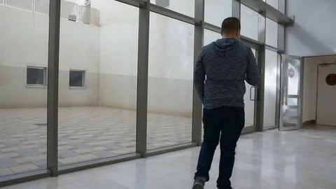 Young man waiting in hall with cellular Видео 82191787
