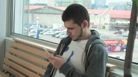 The young man waiting for his flight with suitcases Stock Footage 55741963
