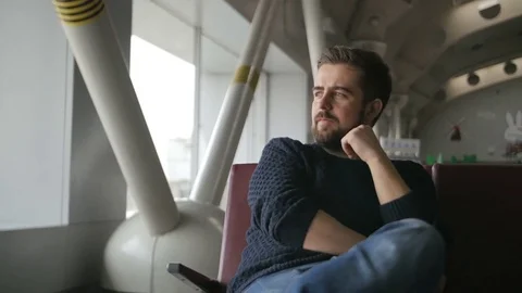 Young man waiting his flight in airport lounge Stock Footage 72734143
