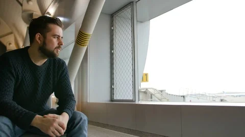 Young man waiting his flight in airport lounge Stock Footage 72734656