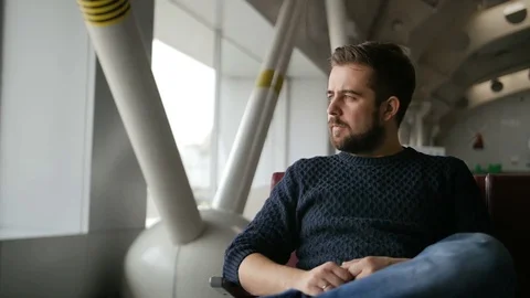 Young man waiting his flight in airport lounge Stock-Footage 73137412
