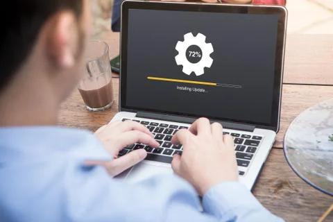 Young man waiting for installing update process with gearbox percentage progress Stock Photos