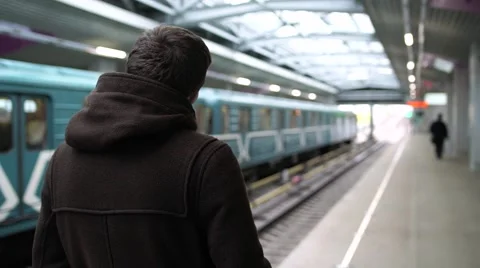 Young man waiting train in a subway station, view from the back Stock Footage 68458800
