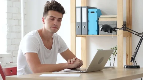 Young Man Waiting at Work for Customer, Late Hours Stock Footage