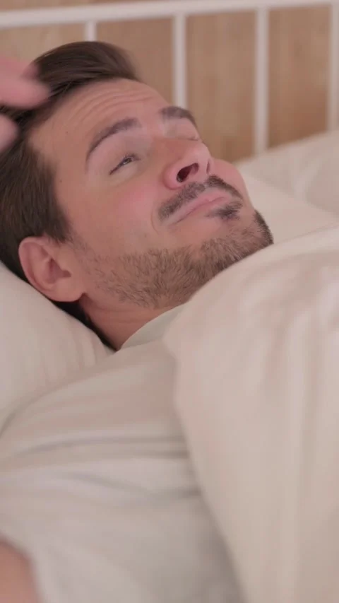 Young Man Waking Up and Leaving Bed, vertical video Vídeo Stock 328564938