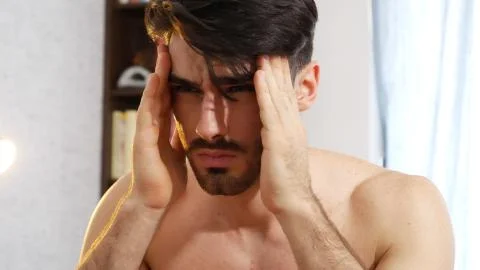 Young man waking up with headache Stock Photos