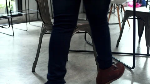 Young man walk in and sit down on chair Stock Footage 101865272