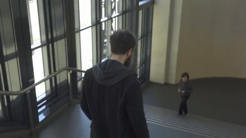 Young Man Walk in Slow Motion Downstairs Stockbeeldmateriaal 73940074