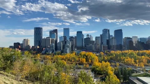 Young Man walking across Bow river bridge towards city center Calgary Stock Footage 168955779